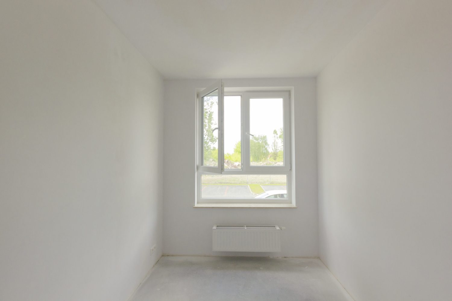 Empty unfinished room with window in a new constructed building