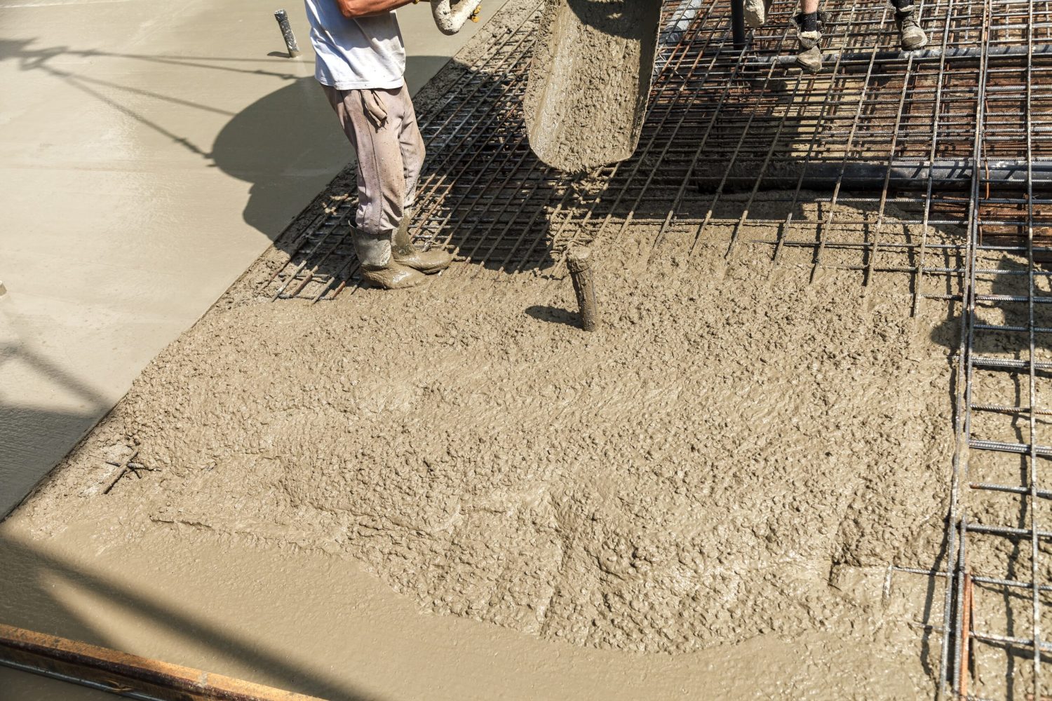 Pouring concrete into the construction of the house. Builders are pouring ready-mixed concrete